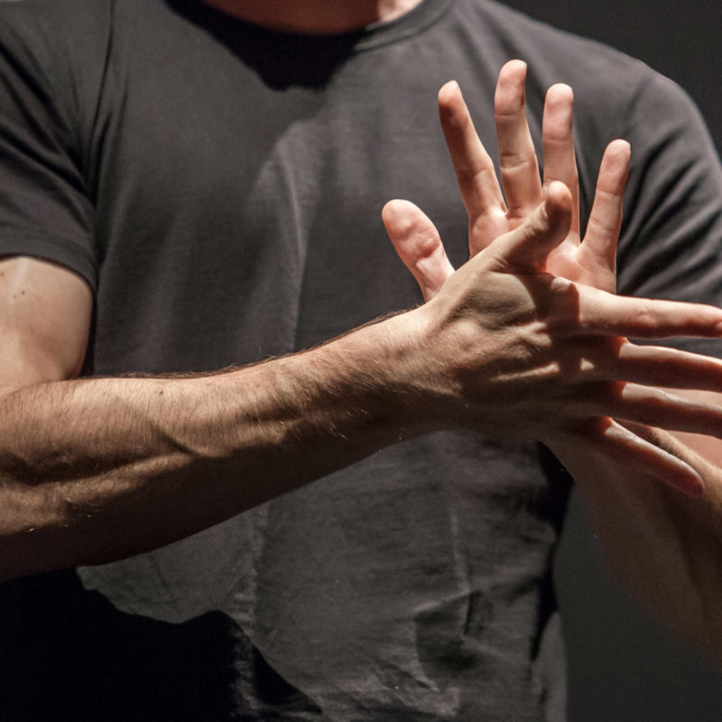 Sign language man interpreter gestures over stage during public